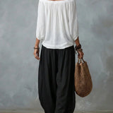 Top con spalle scoperte e pantaloni a lanterna